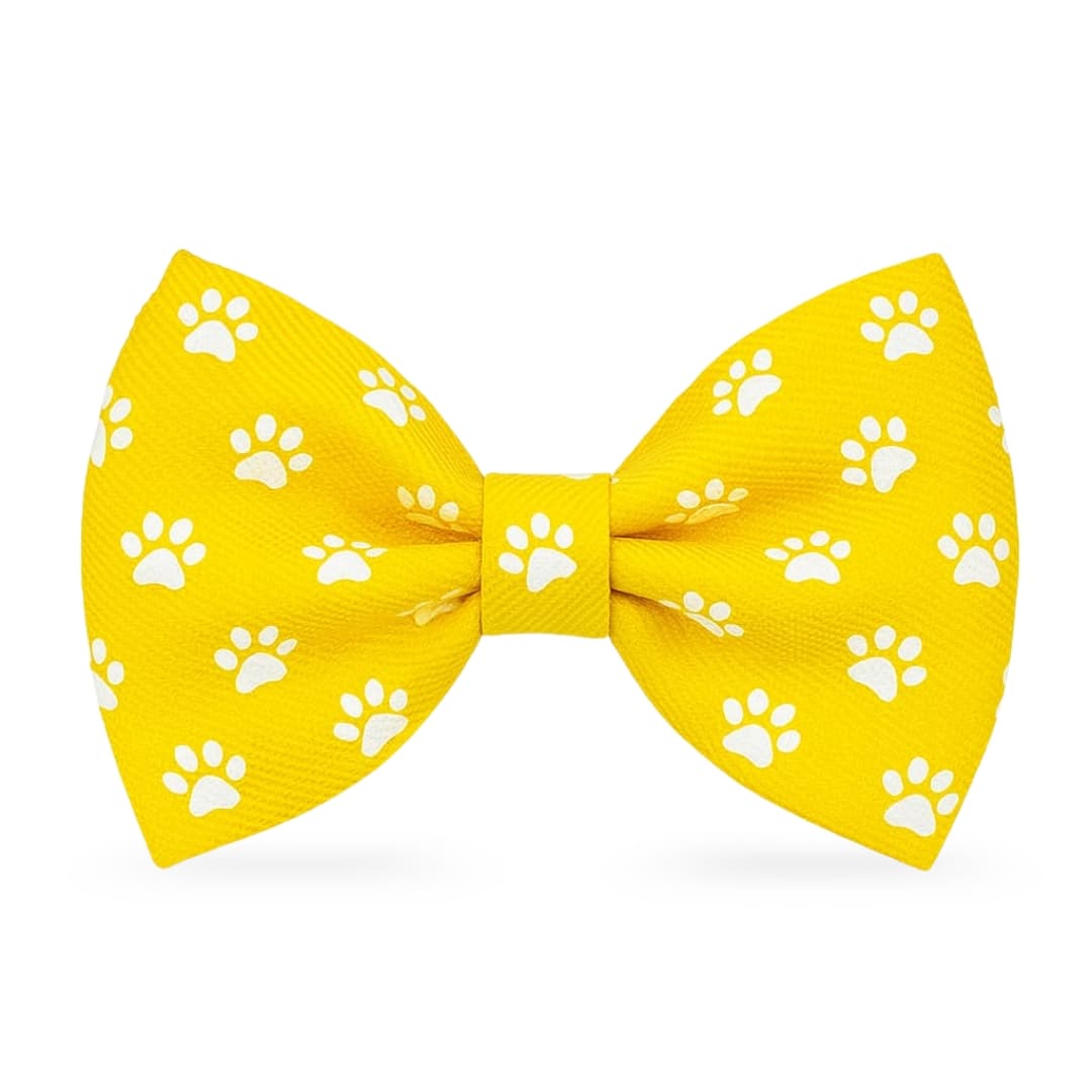 Yellow DuraPaw cute dog bow tie with white paw prints on a white background