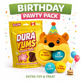 DuraPaw Birthday Pawty Pack featuring a yellow bag of DuraYums Poppin' Pork treats, a plush orange bear toy with a party hat holding three colorful balls labeled 'Time to Party', balloons, and a small birthday cake on a white background with confetti and a green BIRTHDAY PAWY PACK banner.