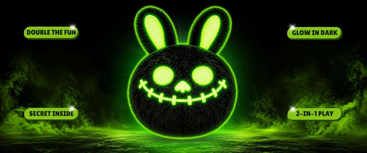 A black spherical glow in the dark bunny-shaped DuraPaw Rippable dog toy with glowing green eyes, nose, and mouth, centered on a dark smoky background with green mist. Text bubbles around it read DOUBLE THE FUN, GLOW IN DARK, SECRET INSIDE, and 2-IN-1 PLAY.