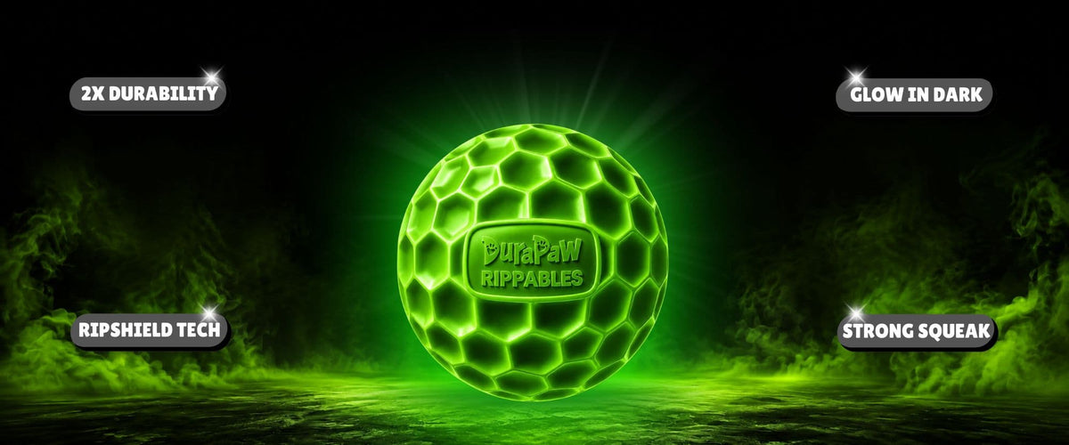 A glowing green RipShield ball with a honeycomb pattern and the DuraPaw Rippables logo in the center, set against a dark background with green mist and feature callouts.