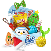 Holiday dog toys and treats filling a blue DuraPaw box, including a green Christmas tree toy, a penguin plush and a candy cane