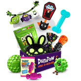 Glow in the Bark Halloween dog toy collection from DuraPaw featuring a spooky black character toy, a vampire coffin toy, a glow in the dark bone, a green spiky glow ball, and Canadian dog treats on a white background