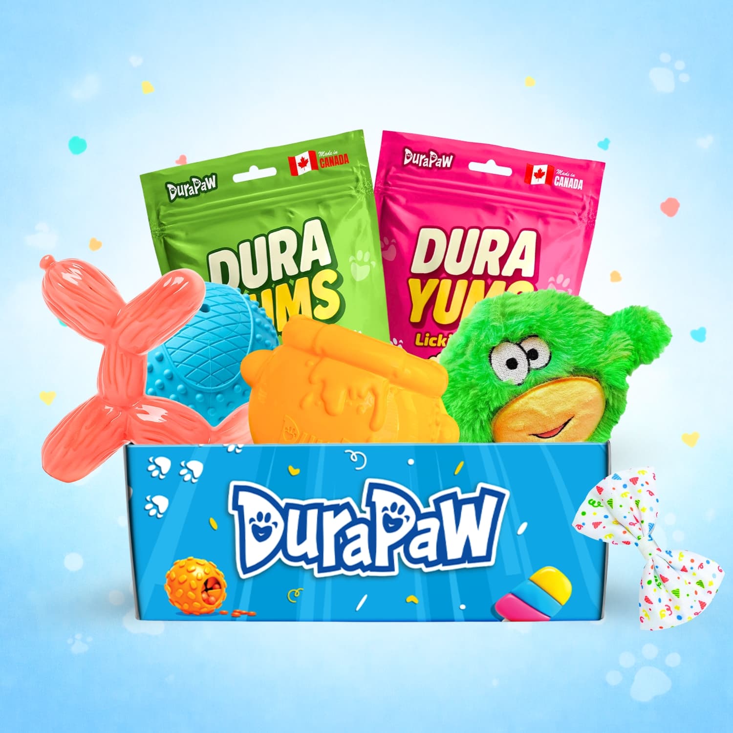DuraPaw pet dog toy subscription box set with colorful packaging on a light blue background