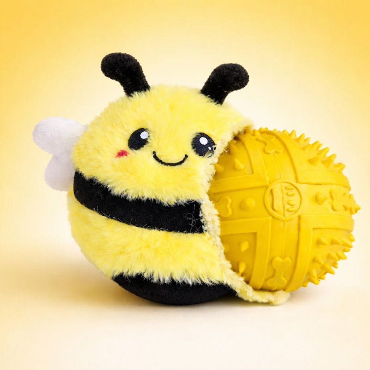 DuraPaw Rippable plush bee 2-in-1 toy with a yellow ball on a beige background